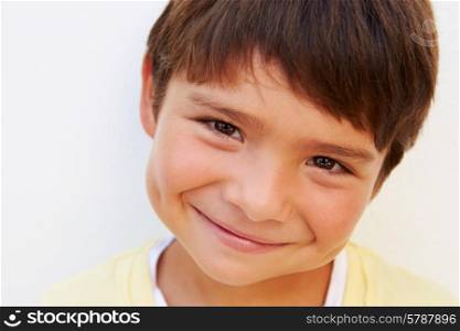 Portrait Of Young Hispanic Boy Standing By Wall