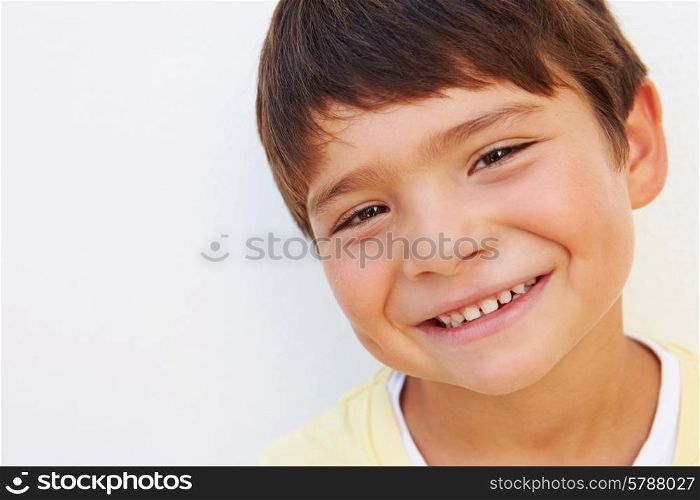 Portrait Of Young Hispanic Boy Standing By Wall