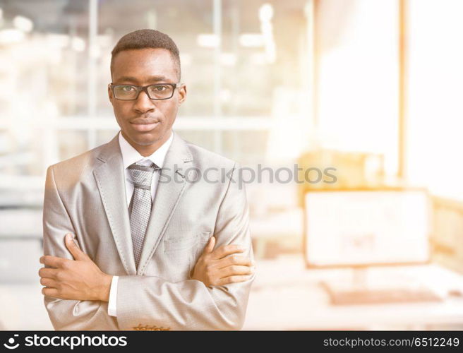 Portrait of young junior businessman in front of his big modern office,. Young businessman in his office