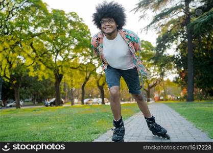 Portrait of young latin man enjoying while rollerskating outdoors on the street. Sports concept. Urban concept.