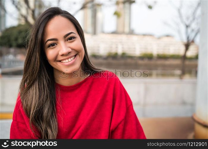 Portrait of young latin woman posing outdoors in the street. Urban concept.