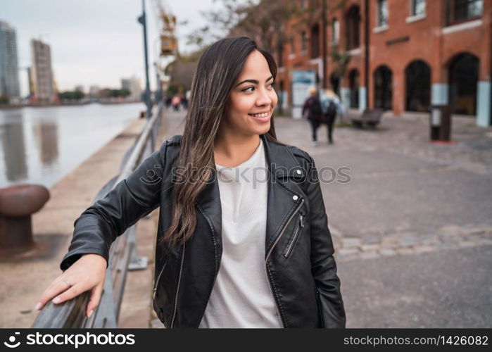 Portrait of young latin woman posing outdoors in the street. Urban concept.