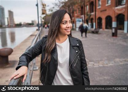 Portrait of young latin woman posing outdoors in the street. Urban concept.