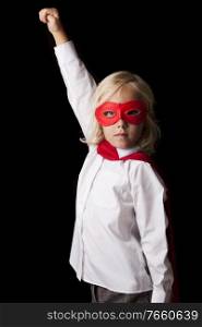 Portrait of young little girl wearing super hero costume in studio