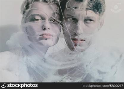Portrait of young lovers entangled web of closeup