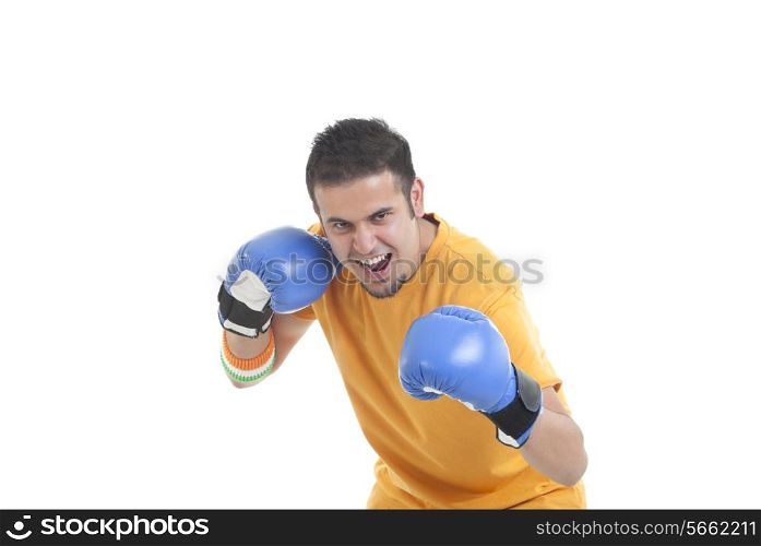 Portrait of young male boxer in a fighting stance over white background