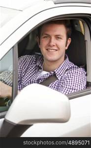 Portrait Of Young Male Driver Looking Out Of Car Window