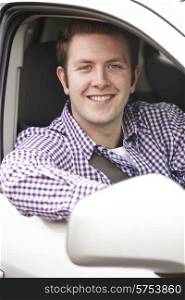 Portrait Of Young Male Driver Looking Out Of Car Window