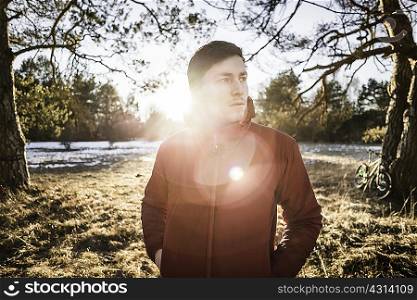 Portrait of young male hiker in lakeside forest