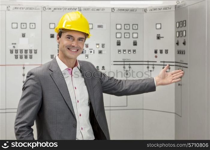 Portrait of young male manager gesturing in control room