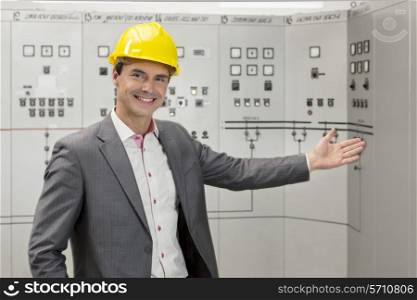 Portrait of young male manager gesturing in control room