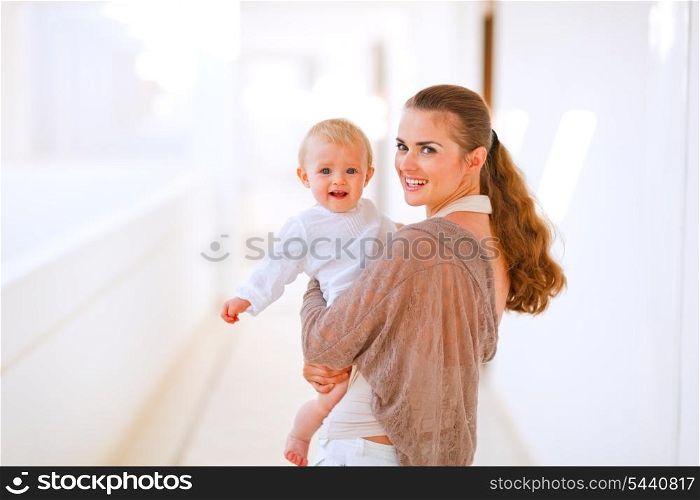 Portrait of young mama with adorable baby in hand&#xA;