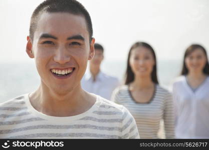 Portrait of Young Man and Friends at Beach