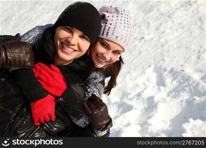 portrait of young man and girl smiling, embracing and looking at camera, winter day