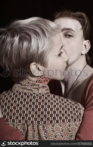 Portrait of young man and woman on a black background