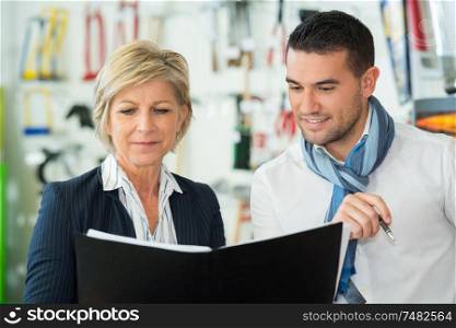 portrait of young man and woman talking at work