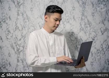 Portrait of young man businessman is holding a notebook and smiling at home