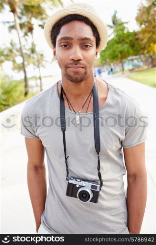 Portrait Of Young Man Carrying Camera