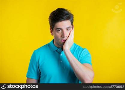 Portrait of young man doing facepalm gesture, like no, I forgot. Unhappy guy feeling sorrow, regret, drama, failure. He isolated on yellow wall.. Portrait of young man doing facepalm gesture, like no, I forgot. Unhappy guy feeling sorrow, regret, drama, failure. He isolated on yellow wall