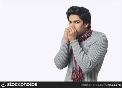 Portrait of young man feeling cold