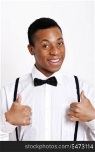 Portrait of young man gesturing thumbs up over white background