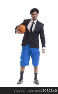 Portrait of young man holding basketball