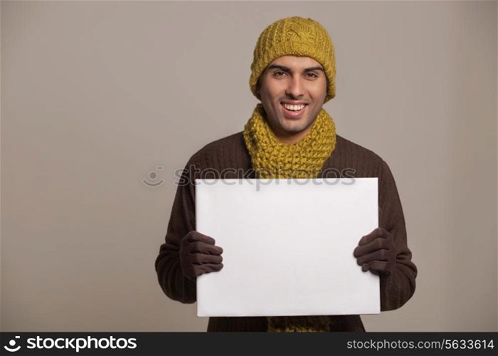Portrait of young man holding bill board