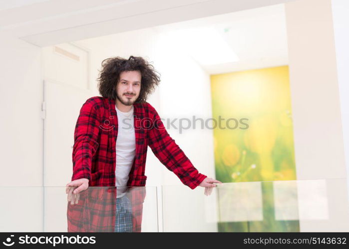 portrait of young man in bathrobe enjoying free time at home