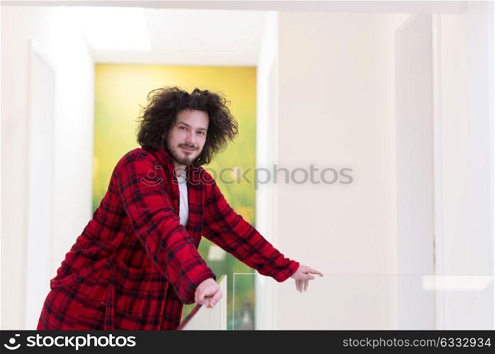 portrait of young man in bathrobe enjoying free time at home