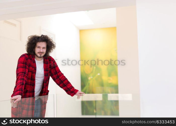 portrait of young man in bathrobe enjoying free time at home