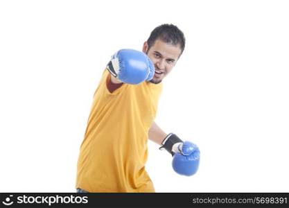 Portrait of young man in fighting stance isolated over white background