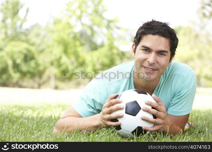 Portrait Of Young Man In Park With Football