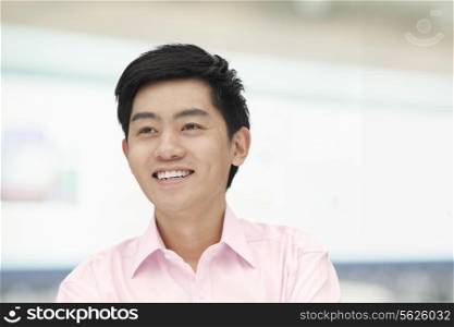 Portrait of young man in pink button down shirt, Beijing, China