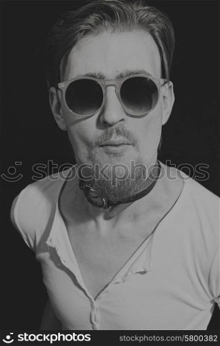 Portrait of young man in round sunglasses closeup