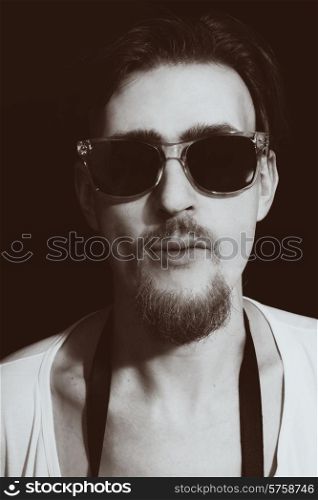 Portrait of young man in round sunglasses closeup&#xA;