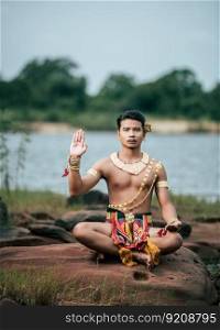 Portrait of Young man in traditional costume which Imagination ima≥of Thailand literature about Serpent king, Folk ta≤s based on the beliefs of the Isan peop≤in Thailand, pose outdoor in nature