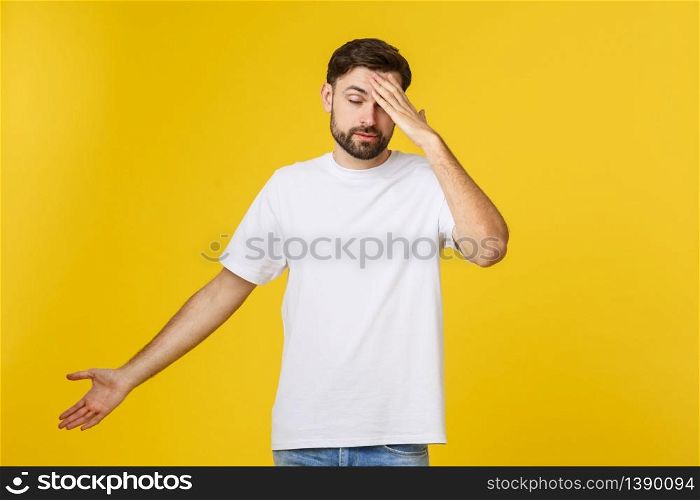 Portrait of young man isolated on yellow background suffering from severe headache, pressing fingers to temples, closing eyes to relieve pain.. Portrait of young man isolated on yellow background suffering from severe headache, pressing fingers to temples, closing eyes to relieve pain