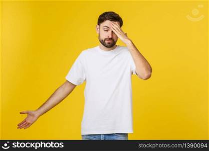 Portrait of young man isolated on yellow background suffering from severe headache, pressing fingers to temples, closing eyes to relieve pain.. Portrait of young man isolated on yellow background suffering from severe headache, pressing fingers to temples, closing eyes to relieve pain