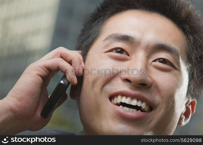 Portrait of young man on the phone, close up
