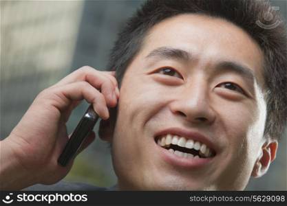 Portrait of young man on the phone, close up