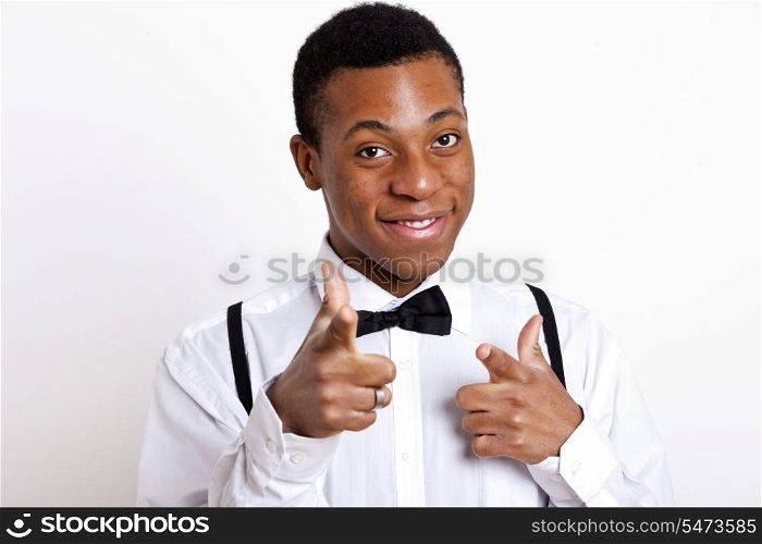 Portrait of young man pointing over white background