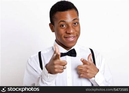 Portrait of young man pointing over white background