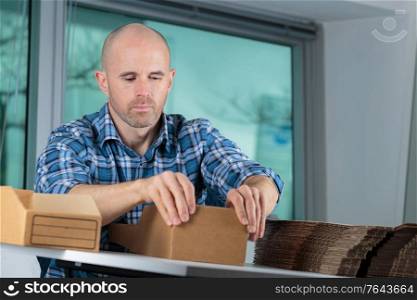 portrait of young man preparing boxes