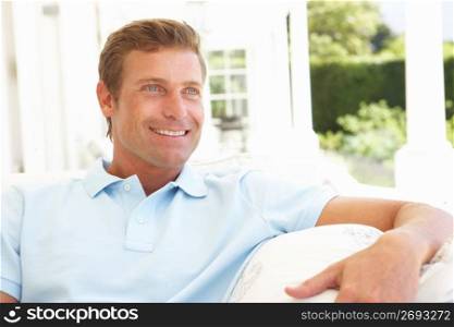 Portrait Of Young Man Relaxing On Sofa