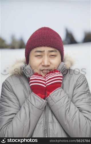 Portrait of young man shivering in cold temperature