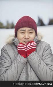 Portrait of young man shivering in cold temperature