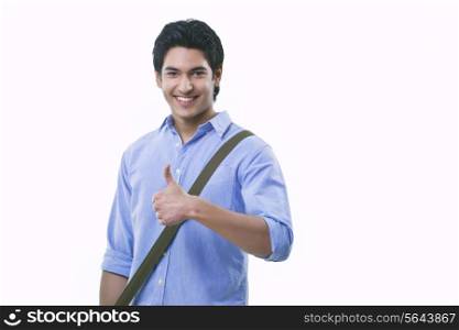 Portrait of young man showing thumps up sign