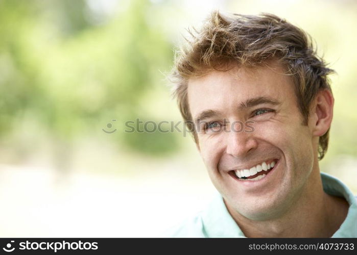 Portrait Of Young Man Sitting In Park