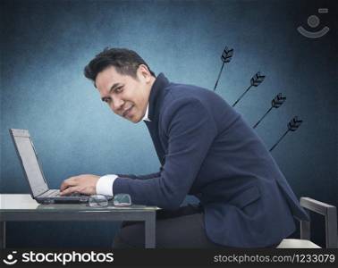 Portrait of young man sitting working on laptop at his desk on white background,Persistence Concept. A man is working harder to achieve new sales target.