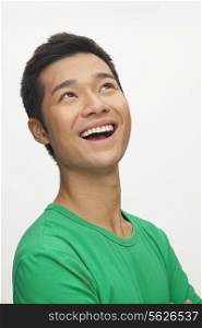 Portrait of young man smiling, white background